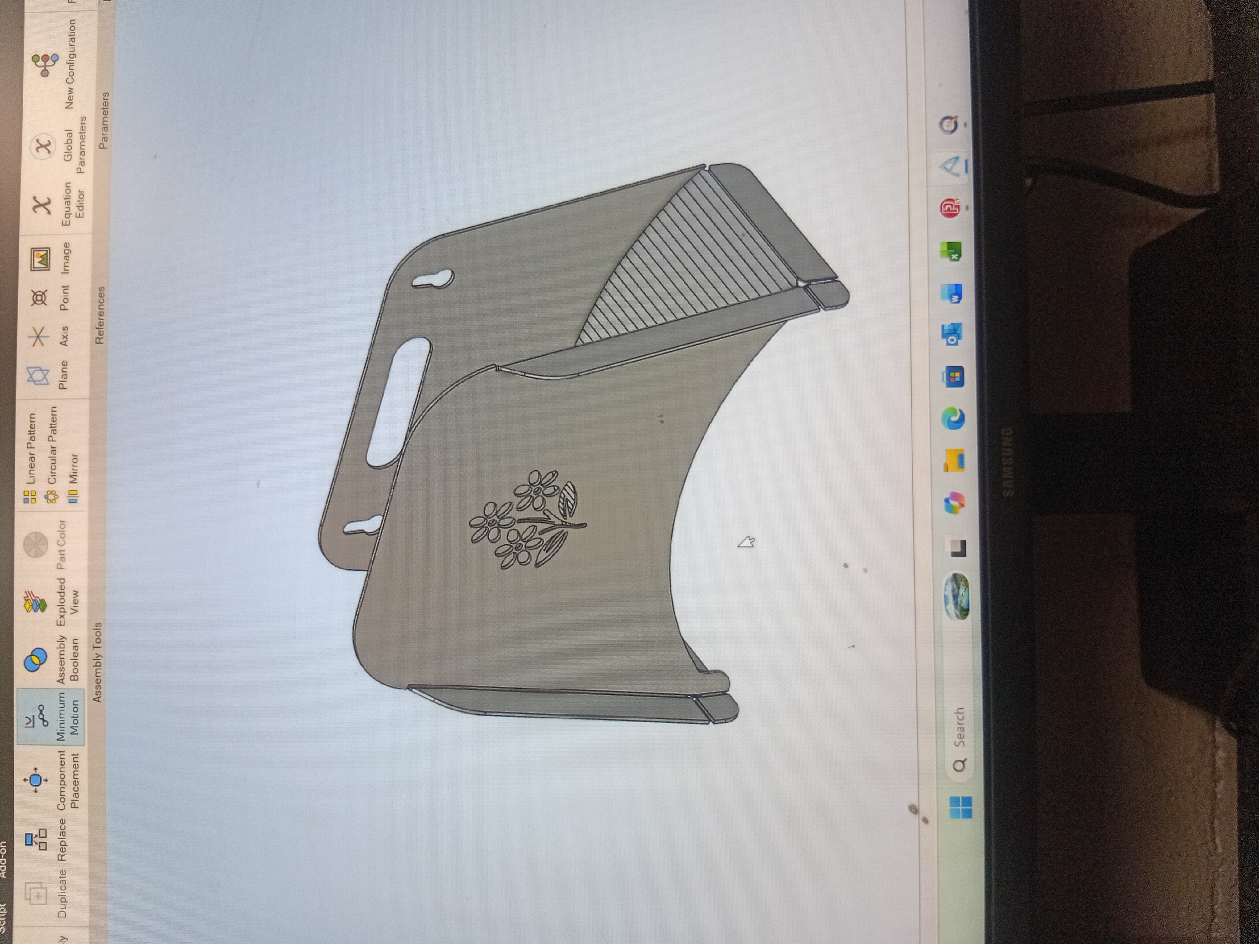 Decorative laser-cut sheet metal bracket with an engraved floral pattern, modelled in CAD